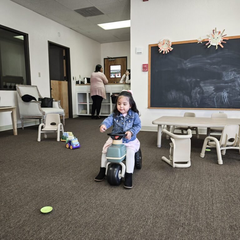 A young child playing in the children's classroom at La Viña